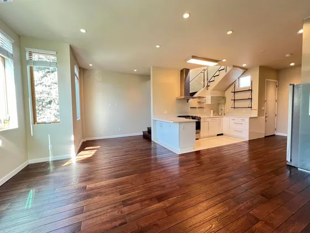 a view of entryway and kitchen with wooden floor