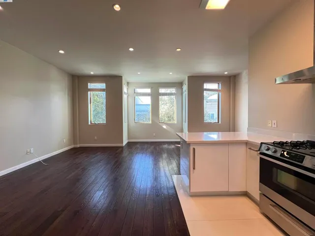 a kitchen with wooden floors and a stove top oven