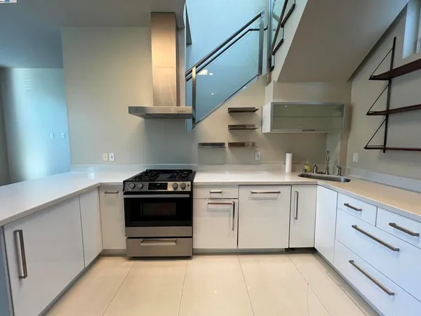 a kitchen with stainless steel appliances granite countertop a stove and a sink