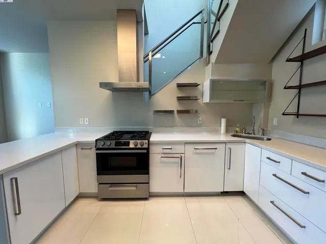 a kitchen with stainless steel appliances granite countertop a stove and a sink