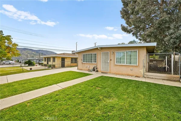 a view of a house with a yard and sitting area