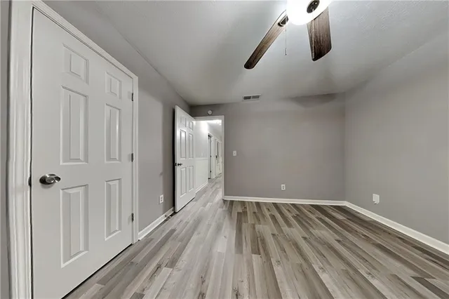 a view of a room with wooden floor