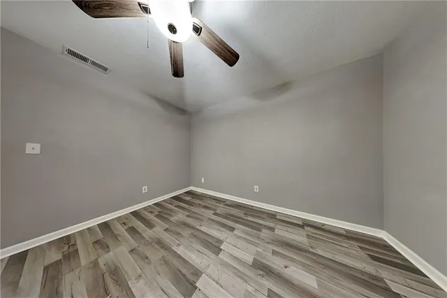 a bathroom with a granite countertop sink a toilet and a mirror