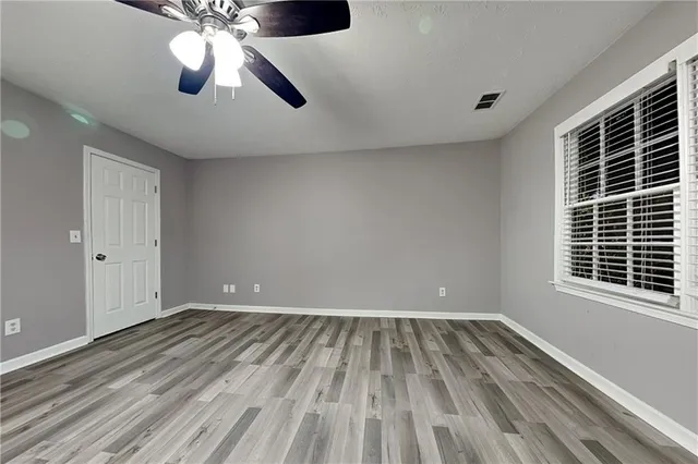 wooden floor in an empty room with a window