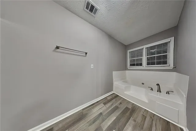 a white toilet sitting next to a shower