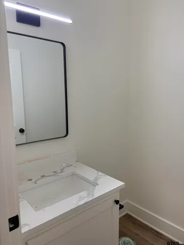 a bathroom with a sink and mirror