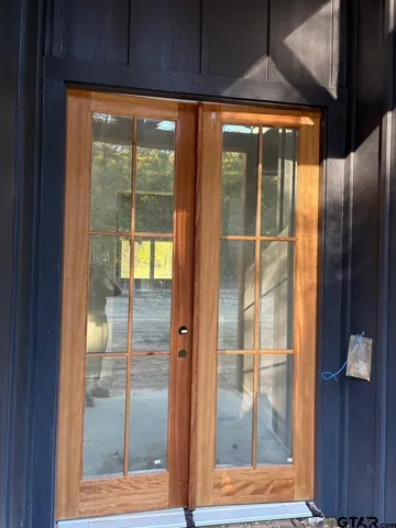 a view of a glass door with wooden floor