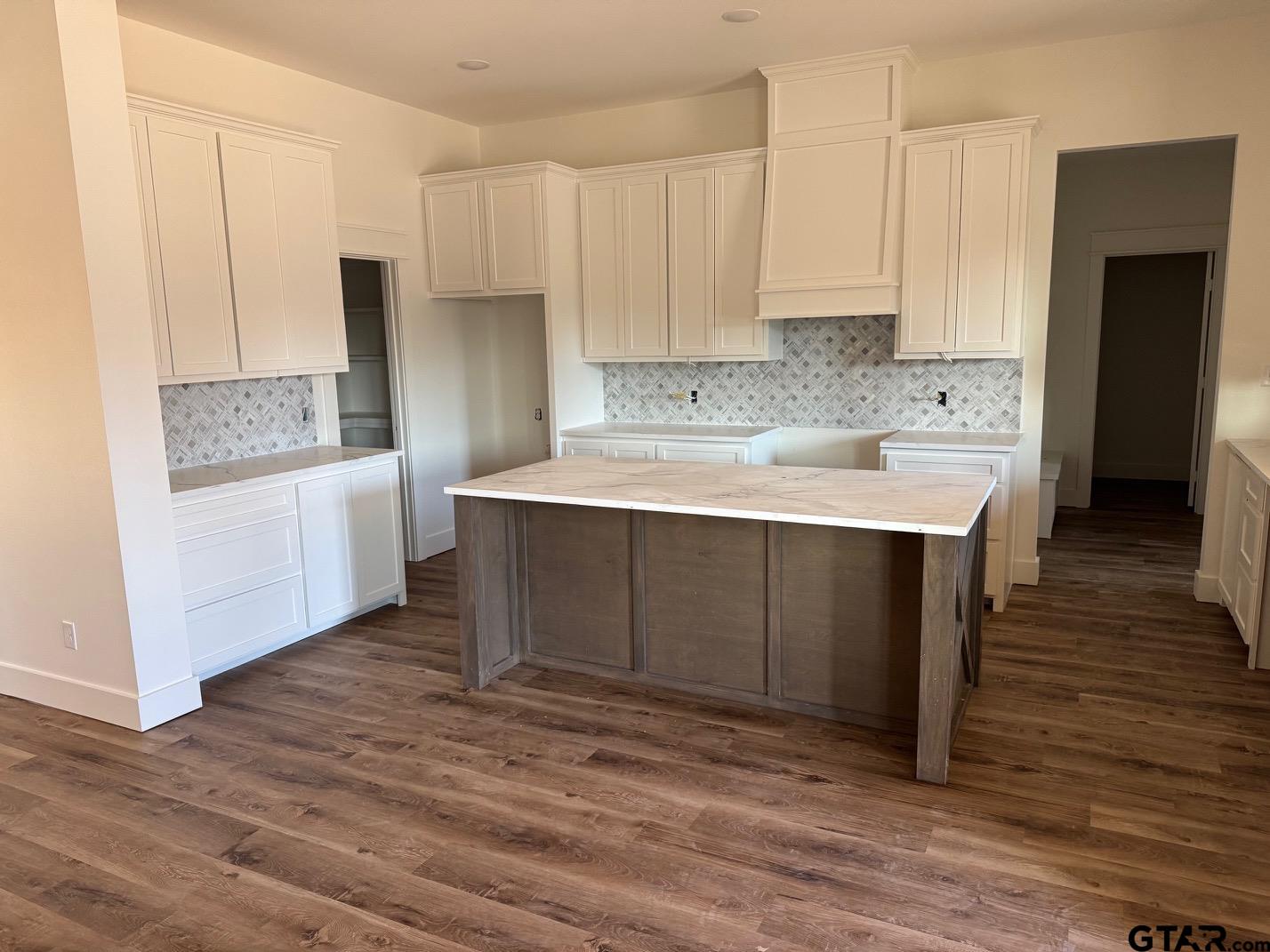 21053 County Road 26 Tyler, TX 75705 - Photo 4 of 19 a kitchen with a sink cabinets and wooden floor