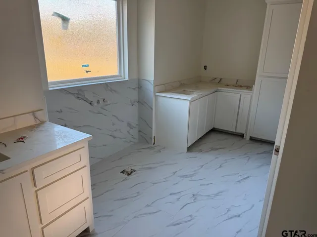 a bathroom with a sink toilet and mirror