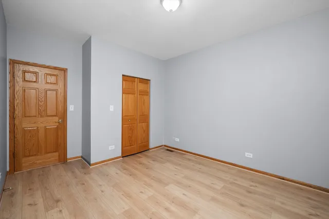 an empty room with closet area