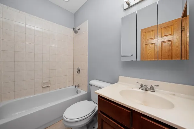 a bathroom with a sink toilet vanity and shower