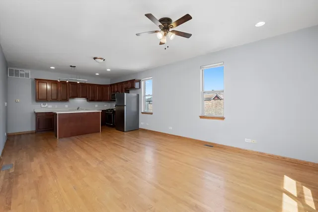 a view of a kitchen with a sink and a refrigerator