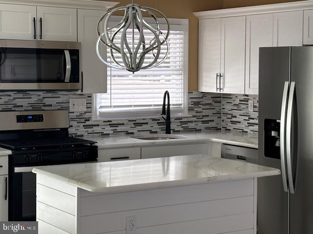 106 Bethel Road Somers Point, NJ 08244 - Photo 13 of 37 a kitchen with granite countertop a refrigerator stove and microwave