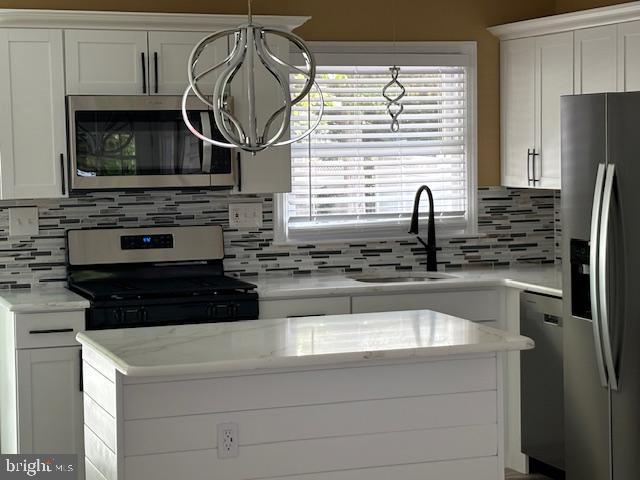 106 Bethel Road Somers Point, NJ 08244 - Photo 16 of 37 a kitchen with stainless steel appliances granite countertop a sink stove and refrigerator