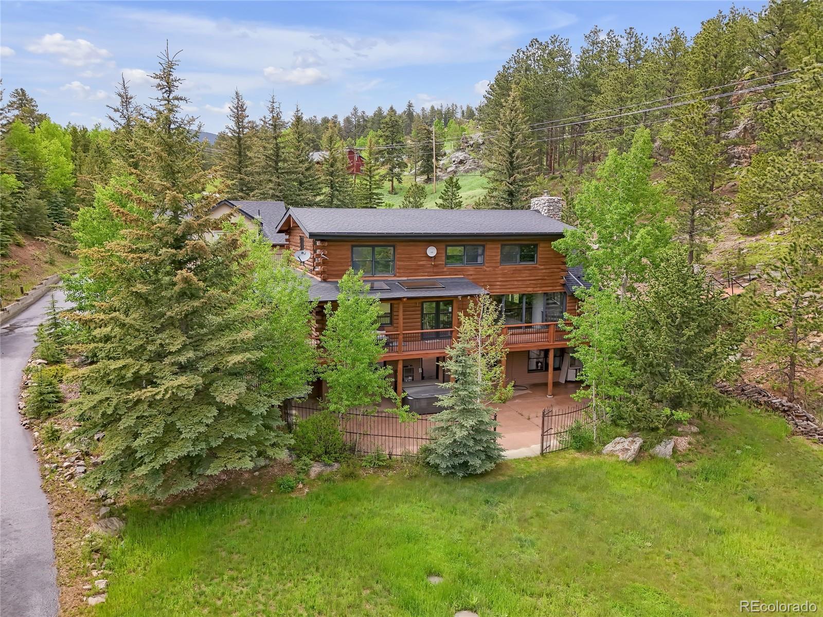 24 Pine Valley Road Evergreen, CO 80439 - Photo 29 of 50 a view of a house with a big yard and large trees