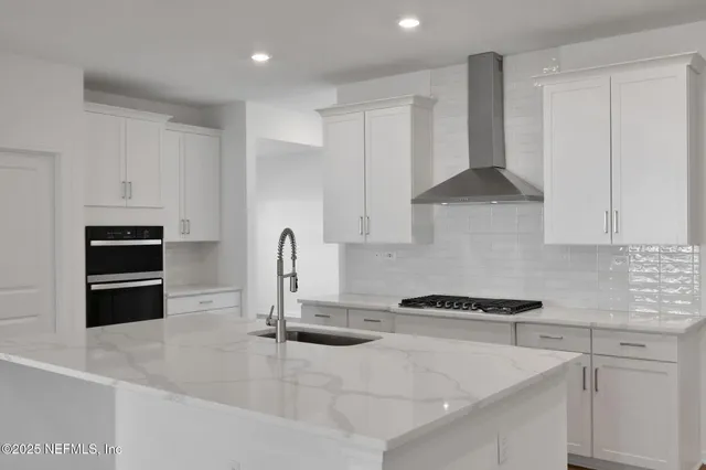 a kitchen with granite countertop a sink and cabinets