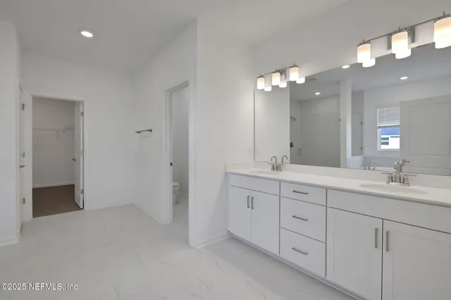 a bathroom with a double vanity sink and a mirror