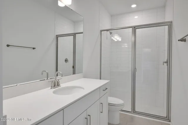 a bathroom with a toilet a sink a mirror a vanity and vanity