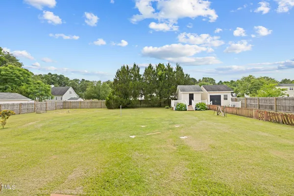 a front view of a house with a big yard