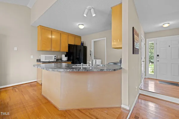 a kitchen with stainless steel appliances granite countertop a sink and cabinets