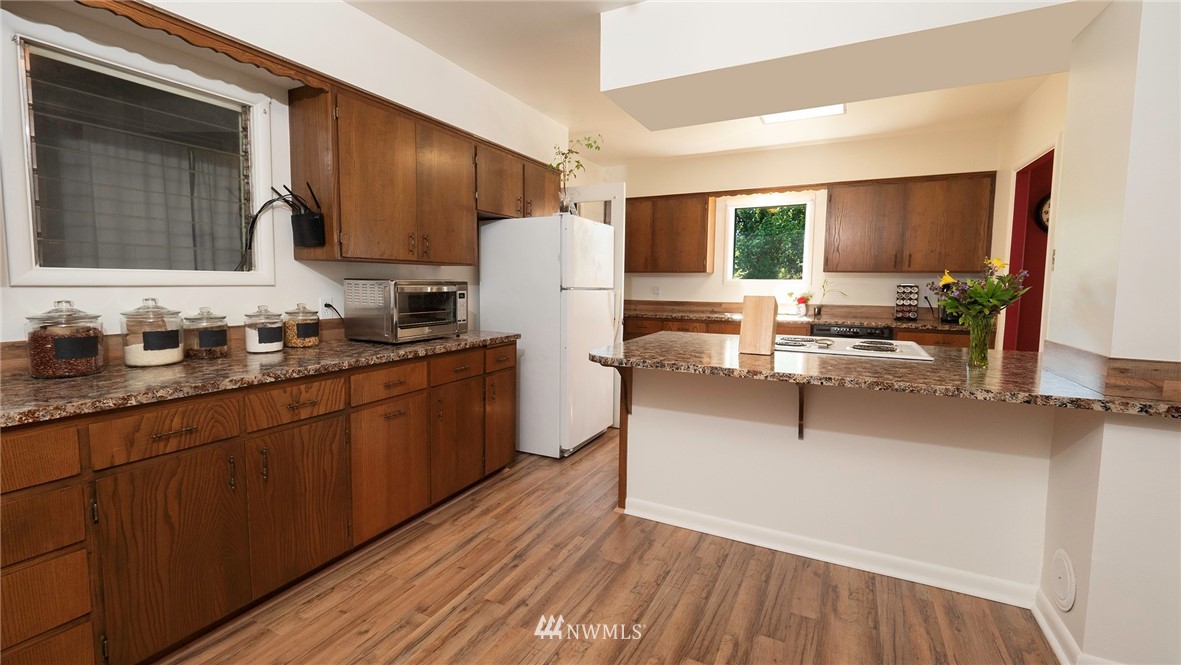 1849 Trigg Road Ferndale, WA 98248 - Photo 13 of 38 a kitchen with wooden cabinets and a sink