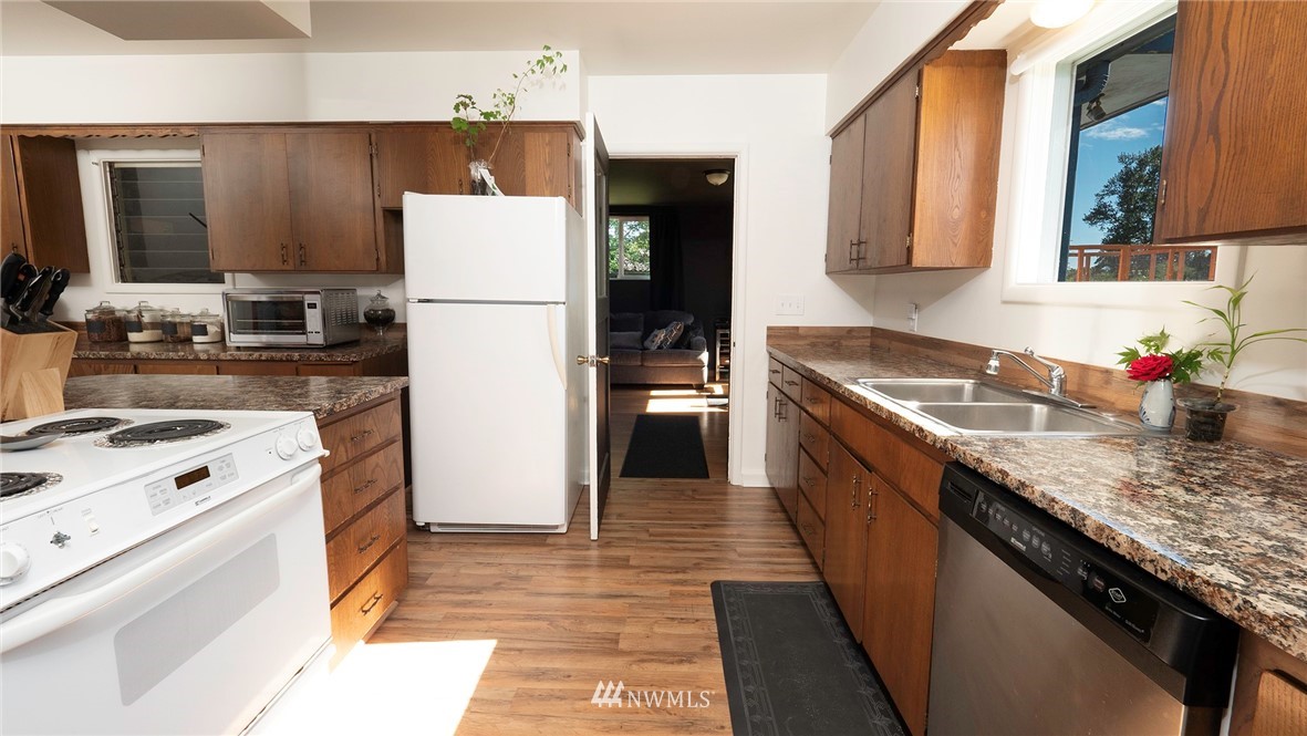 1849 Trigg Road Ferndale, WA 98248 - Photo 14 of 38 a kitchen with a sink a stove and refrigerator