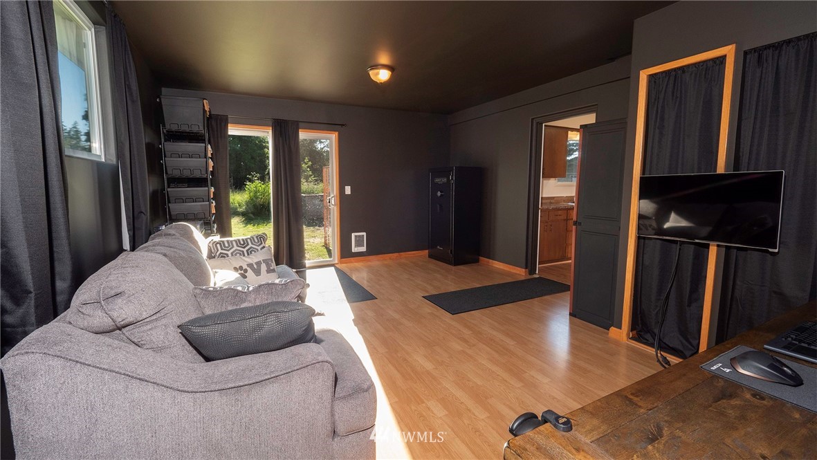 1849 Trigg Road Ferndale, WA 98248 - Photo 16 of 38 a living room with furniture a large window and wooden floor