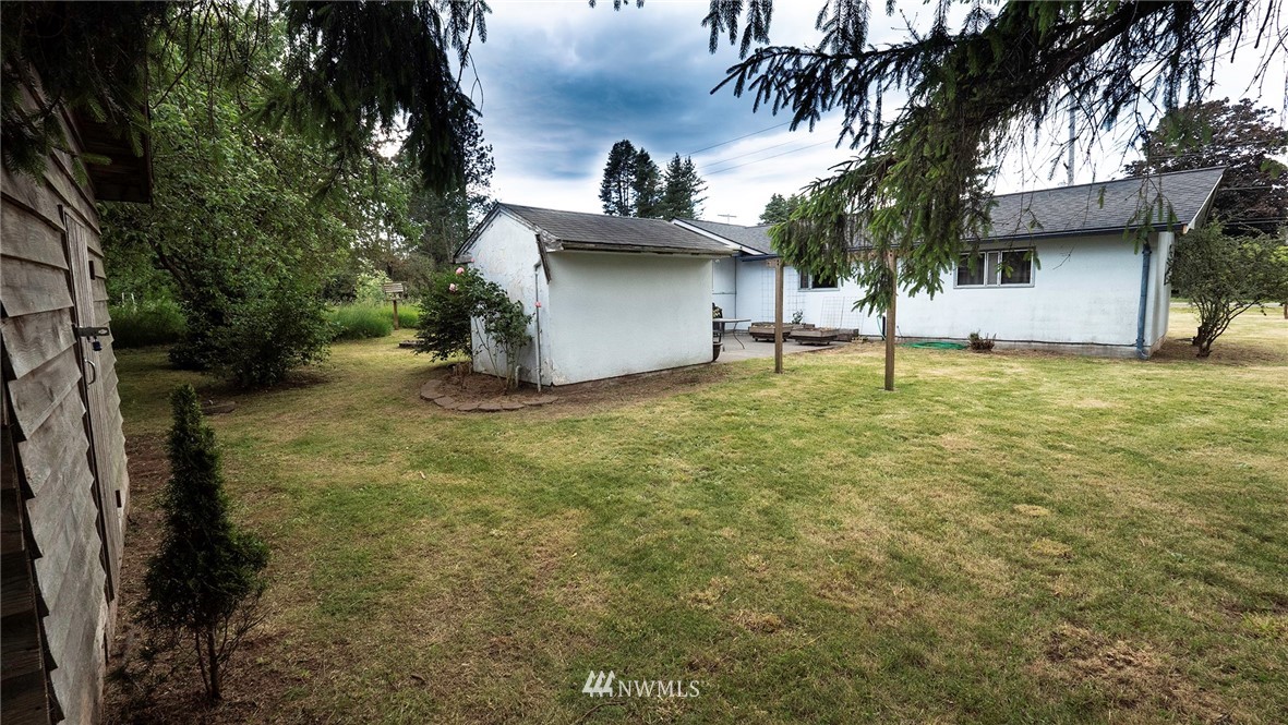 1849 Trigg Road Ferndale, WA 98248 - Photo 28 of 38 a view of a tree in front of a house with a small yard