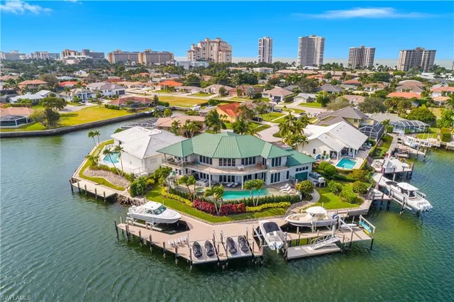 an aerial view of a house with a garden and lake view