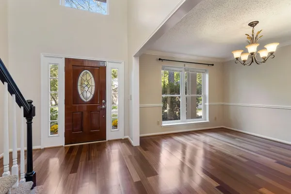a kitchen with stainless steel appliances granite countertop white cabinets and a stove top oven