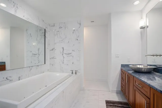 a bathroom with a bathtub and a sink