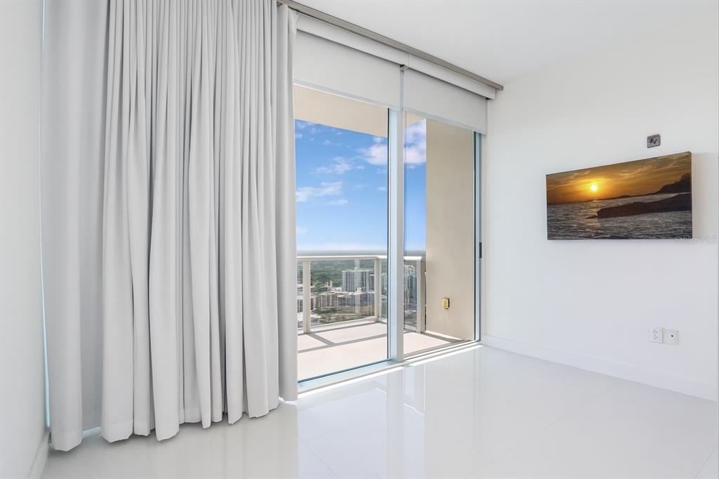 150 East Robinson Street, Unit 29B Orlando, FL 32801 - Photo 20 of 27 a view of an empty room with a flat screen tv and kitchen view