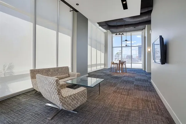 a living room with furniture and large window
