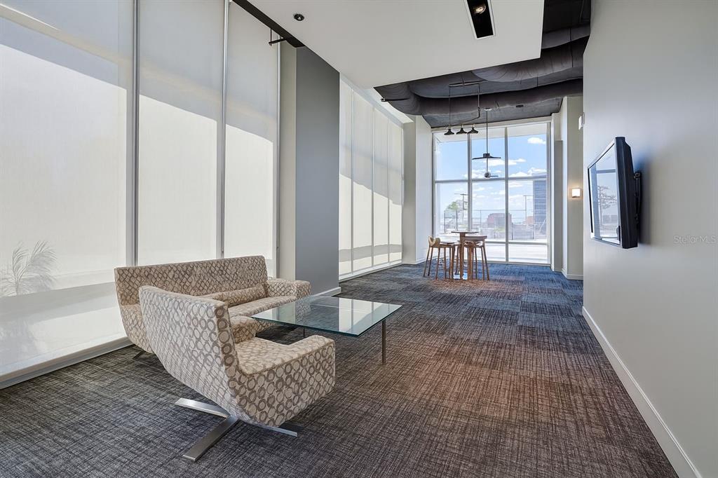 150 East Robinson Street, Unit 29B Orlando, FL 32801 - Photo 25 of 27 a living room with furniture and large window