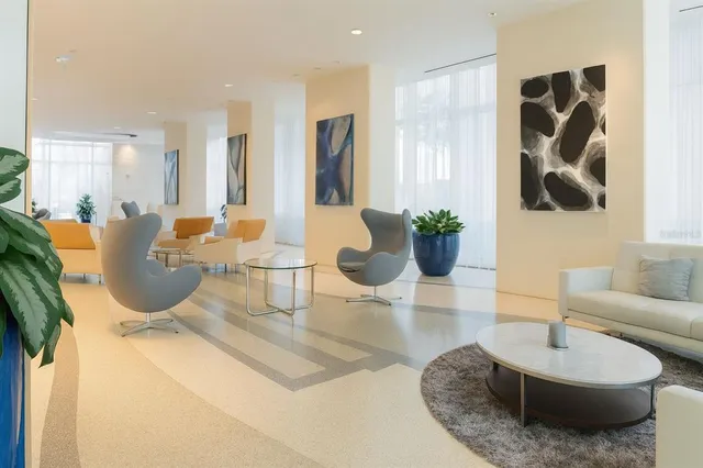 a living room with furniture and potted plant