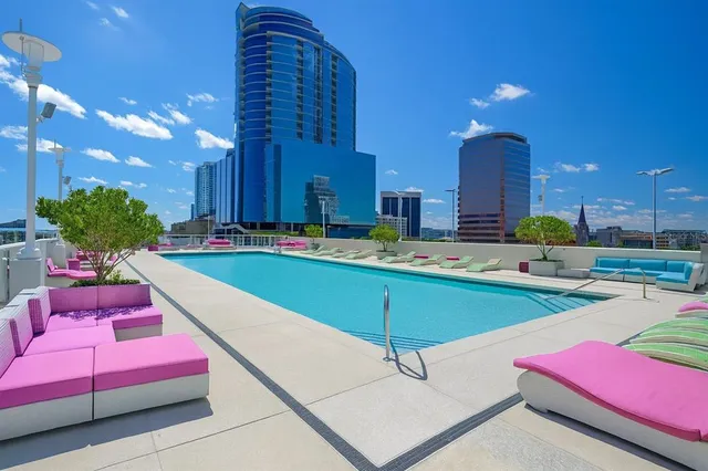 a swimming pool with outdoor seating and yard