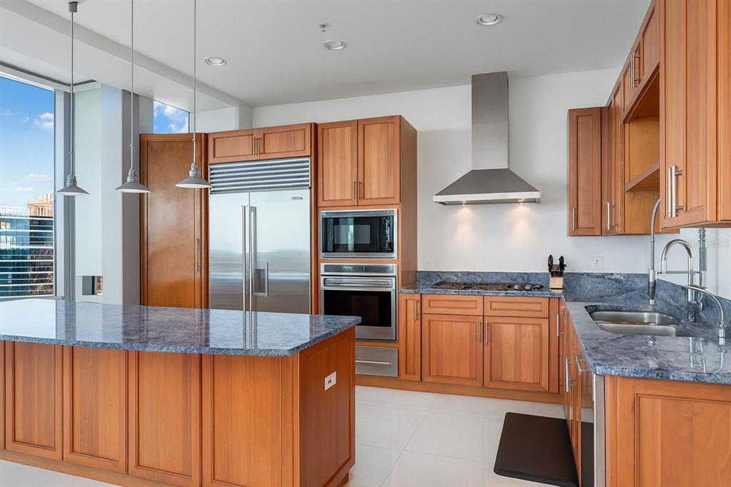 150 East Robinson Street, Unit 29B Orlando, FL 32801 - Photo 7 of 27 a kitchen with stainless steel appliances granite countertop a refrigerator a stove and a sink