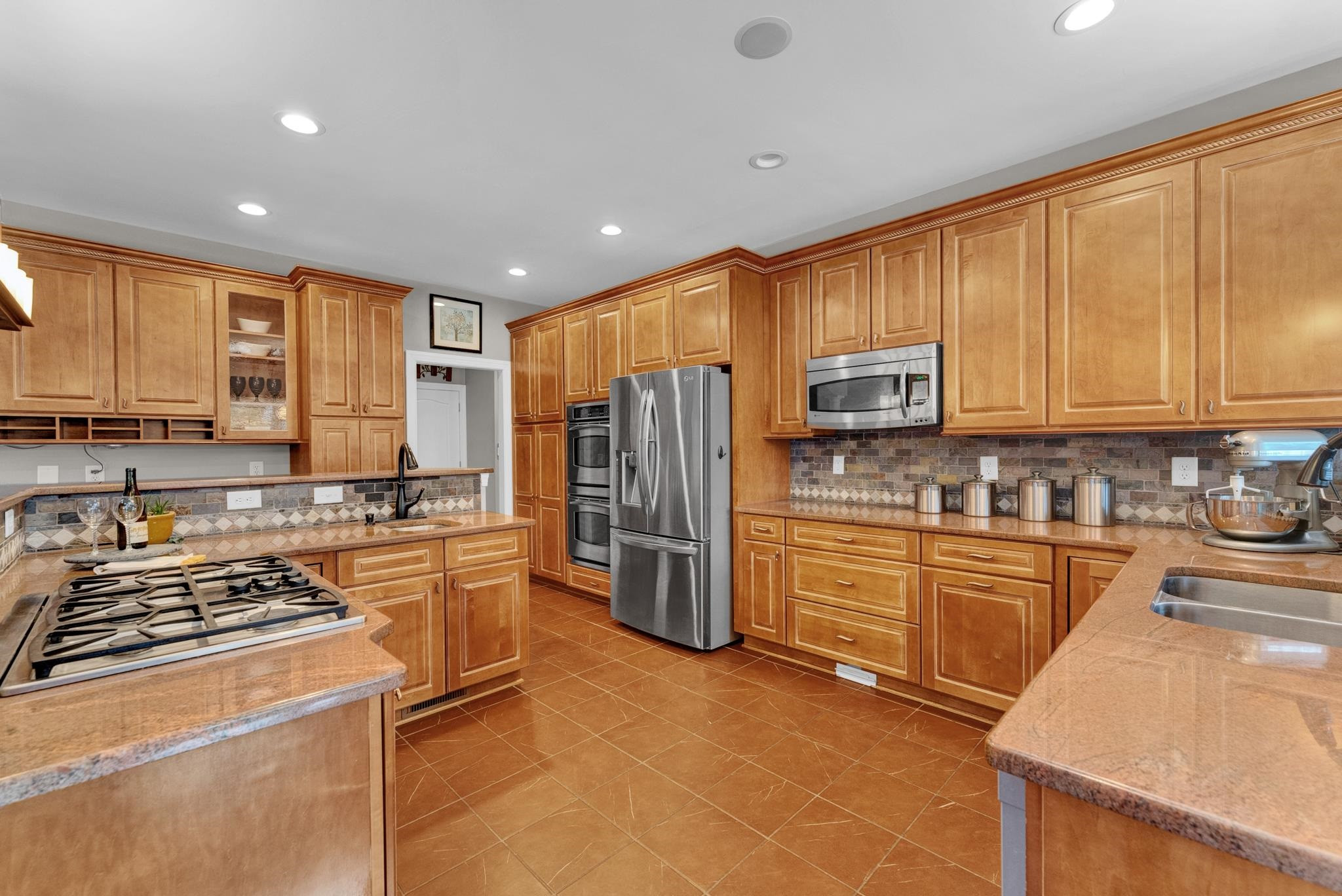 118 Citation Circle Durham, NC 27704 - Photo 9 of 67 a kitchen with kitchen island granite countertop a stove top oven a sink dishwasher a refrigerator and cabinets with wooden floor
