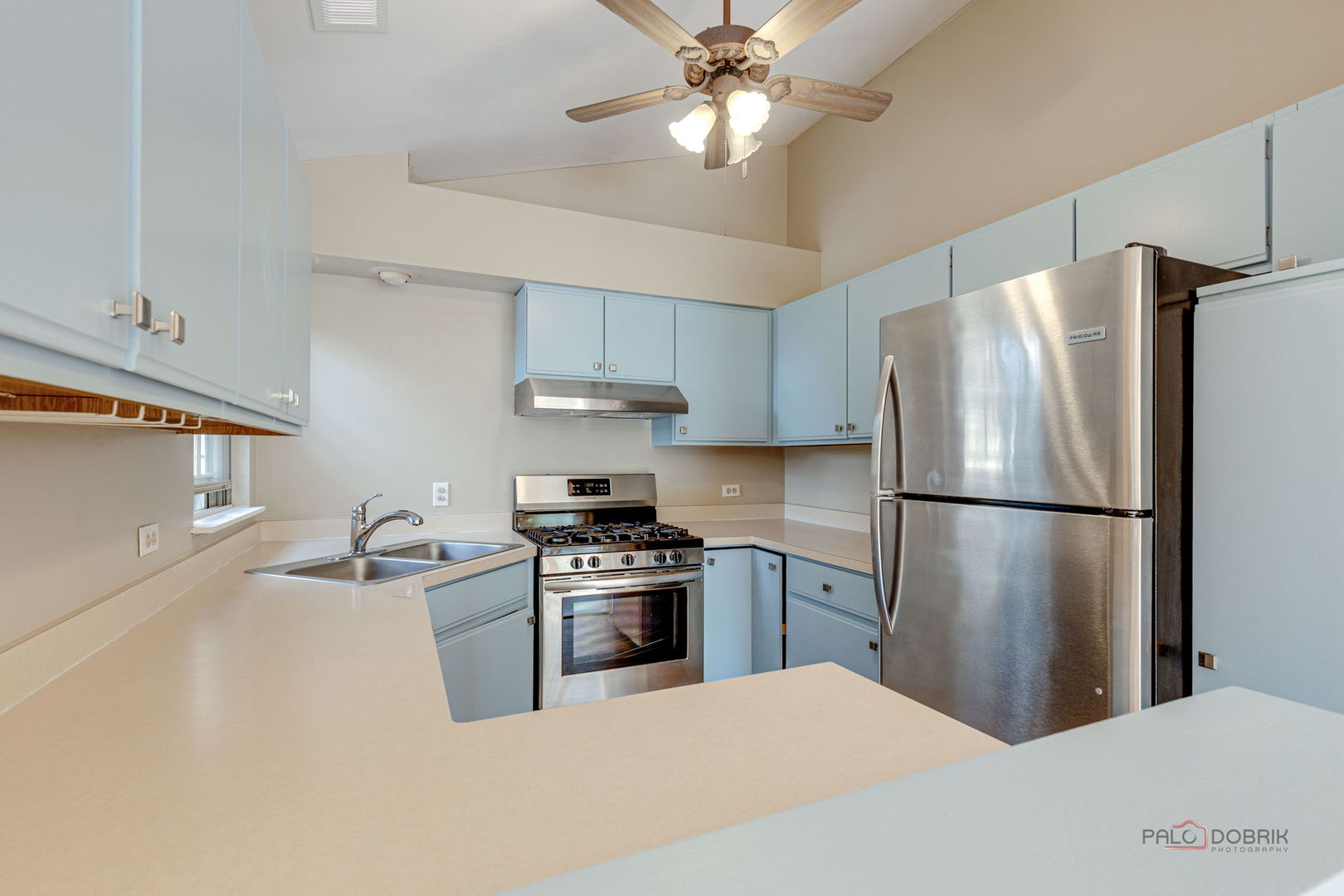 925 Ridgefield Lane Wheeling, IL 60090 - Photo 15 of 25 a kitchen with stainless steel appliances a refrigerator a stove a sink and white cabinets