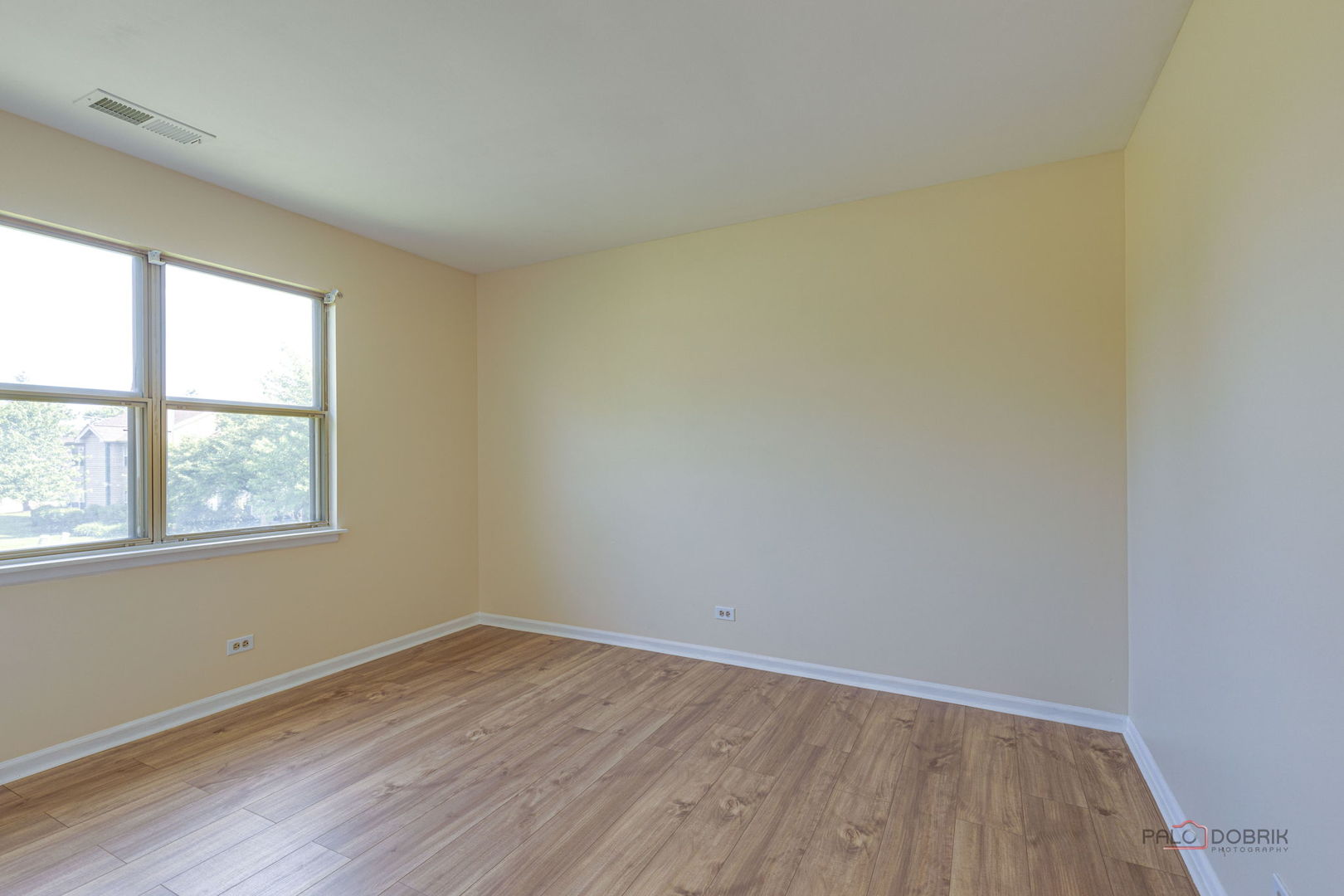925 Ridgefield Lane Wheeling, IL 60090 - Photo 17 of 25 an empty room with wooden floor and windows