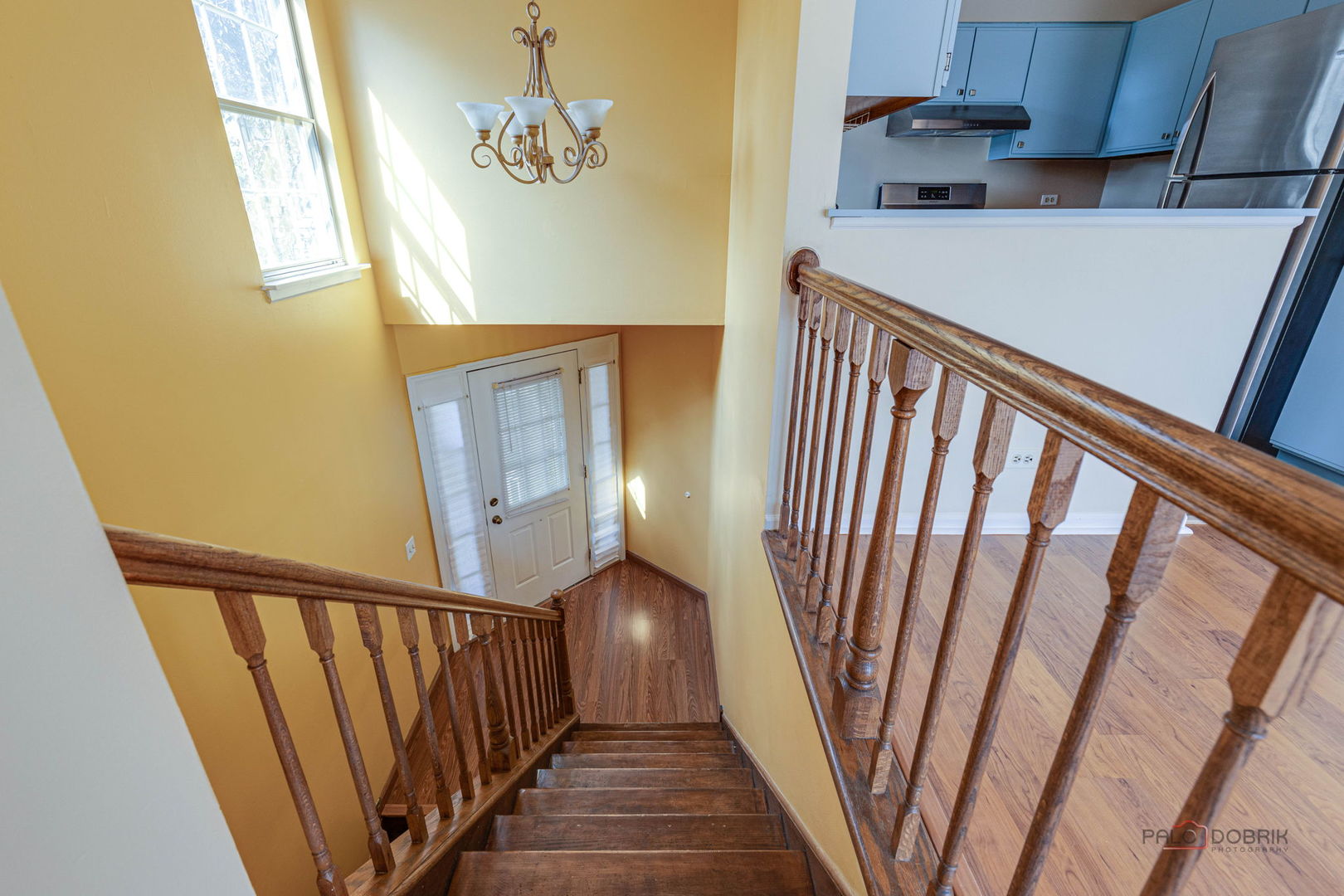 925 Ridgefield Lane Wheeling, IL 60090 - Photo 5 of 25 a view of a hallway with wooden floor and stairs