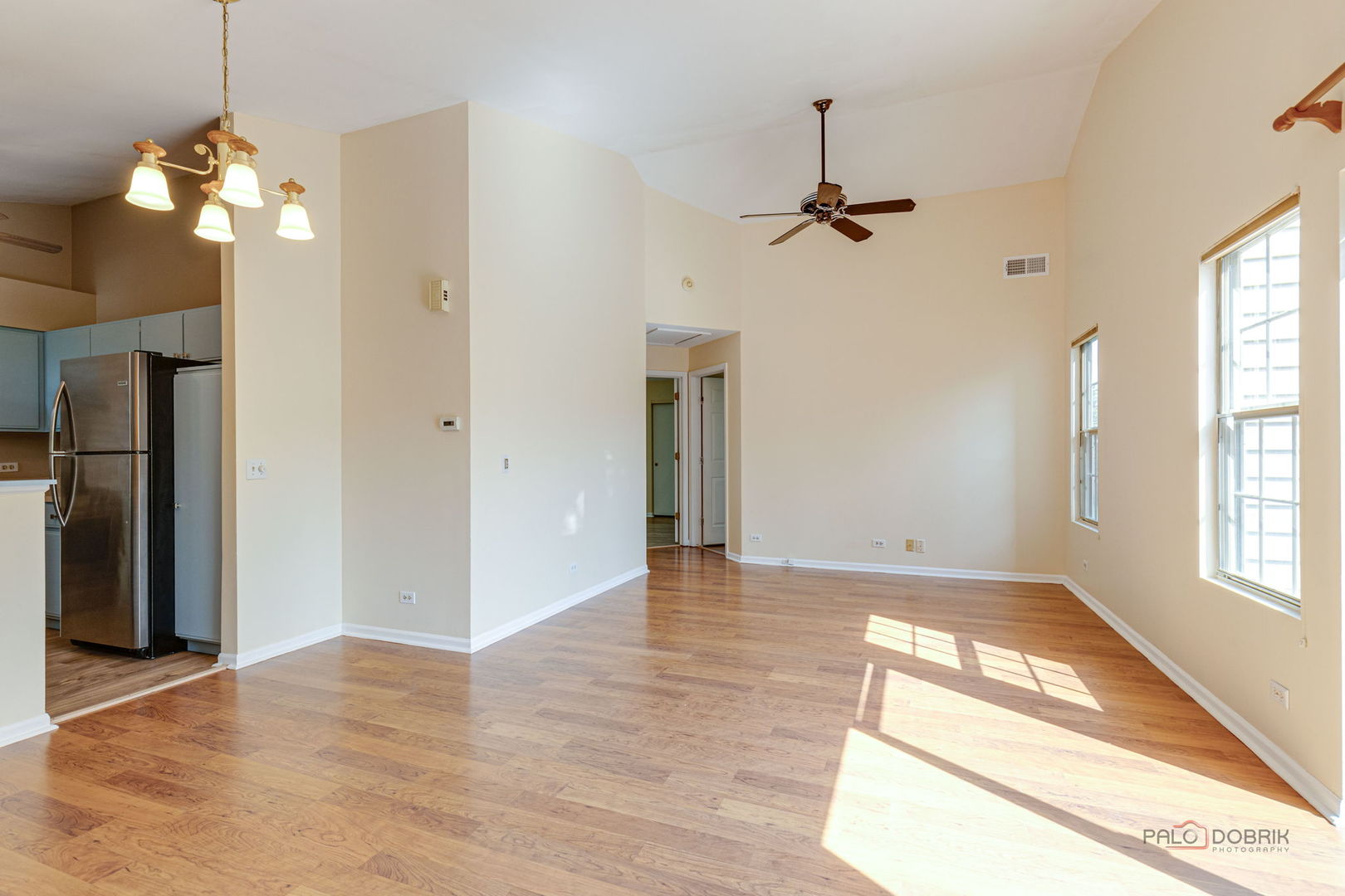 925 Ridgefield Lane Wheeling, IL 60090 - Photo 7 of 25 an empty room with windows and ceiling fan