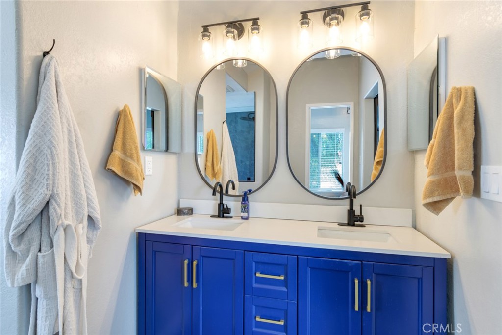 20970 Rider Street Perris, CA 92570 - Photo 14 of 29 a bathroom with a double vanity sink and a mirror