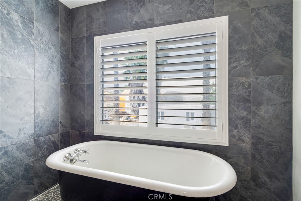 20970 Rider Street Perris, CA 92570 - Photo 16 of 29 a bathroom with a bathtub and next to a window