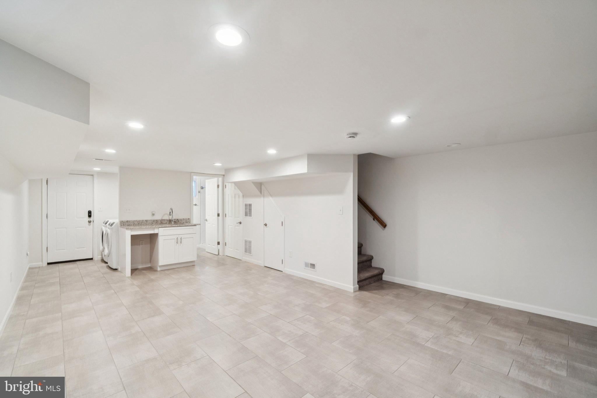 6216 5th Street Northwest Washington, DC 20011 - Photo 16 of 21 an empty room with a kitchen and a sink