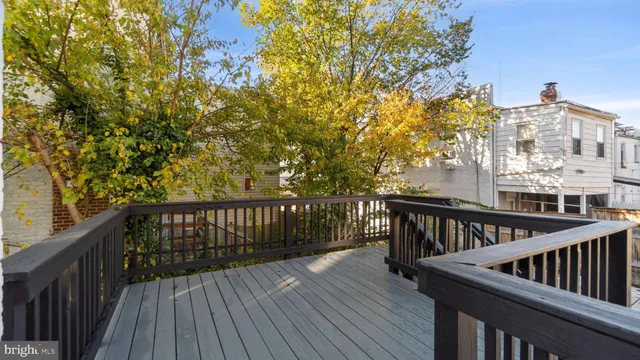 a view of balcony with wooden floor and fence