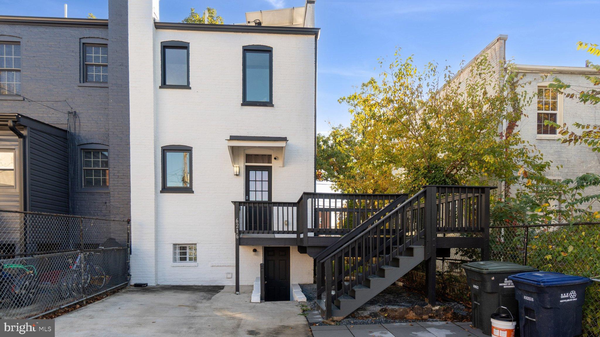 6216 5th Street Northwest Washington, DC 20011 - Photo 21 of 21 a view of a house with large windows and wooden fence