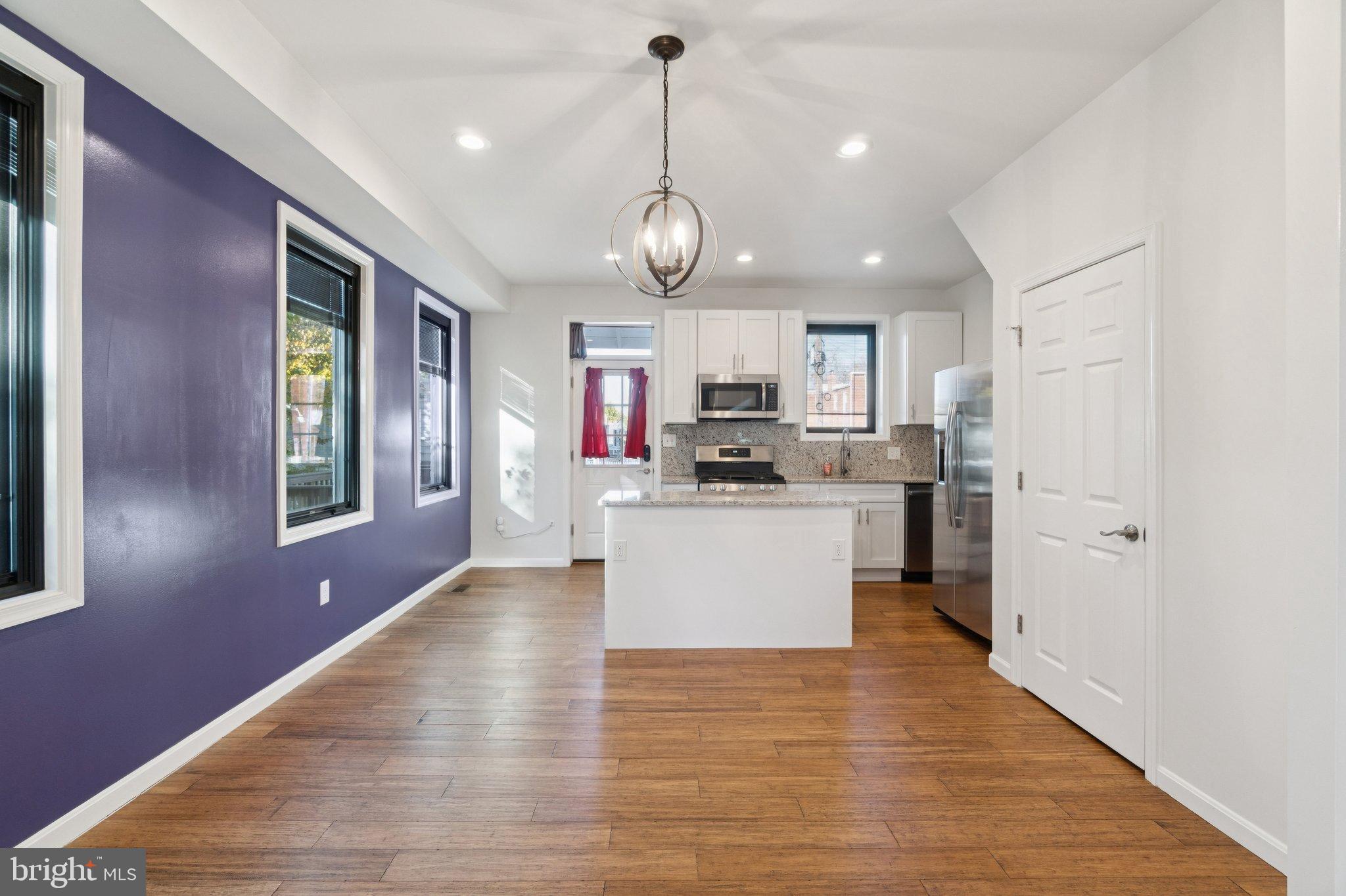6216 5th Street Northwest Washington, DC 20011 - Photo 5 of 21 a large kitchen with kitchen island white cabinets and stainless steel appliances