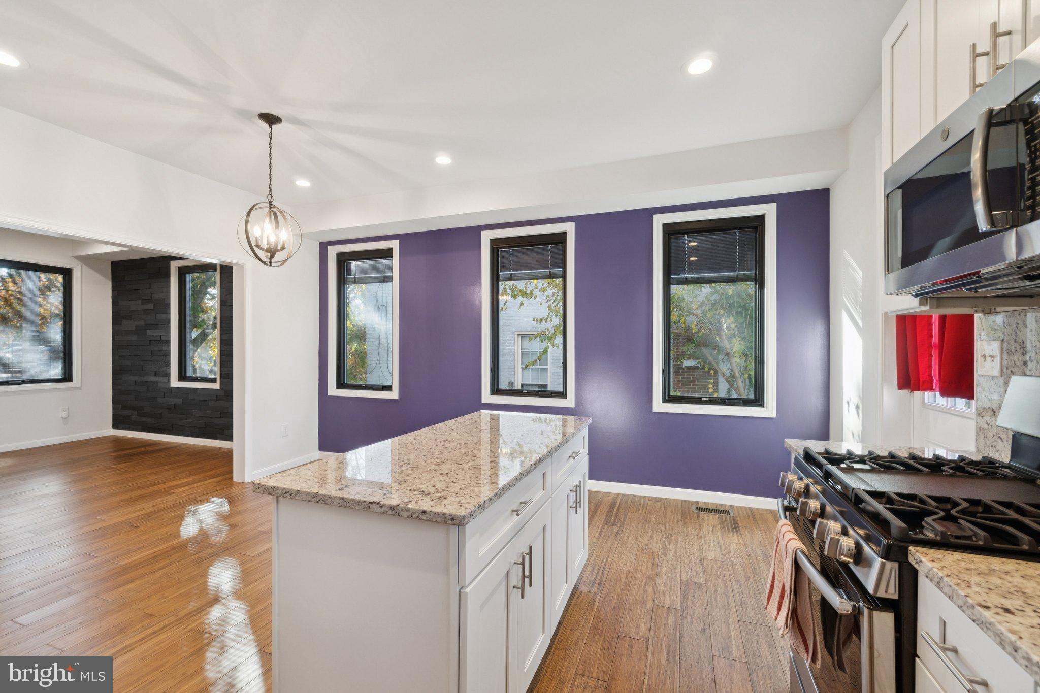 6216 5th Street Northwest Washington, DC 20011 - Photo 8 of 21 a kitchen that has a stove and a wooden floor