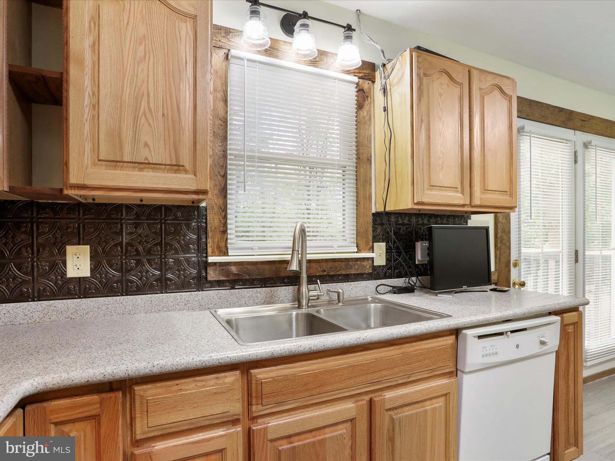 95 Traveller Road Falling Waters, WV 25419 - Photo 16 of 42 a kitchen with stainless steel appliances granite countertop a sink a granite counter tops and a window